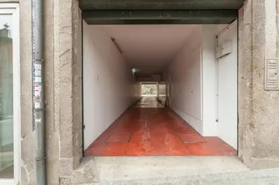an empty hallway with a red floor in a building at Go2oporto - Fontainhas Apartments in Porto