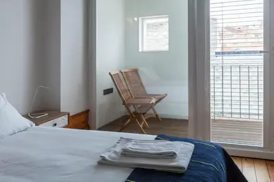 a bedroom with a bed with a towel on it at Go2oporto - Fontainhas Apartments in Porto