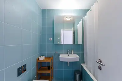 a blue bathroom with a sink and a mirror at Go2oporto - Fontainhas Apartments in Porto