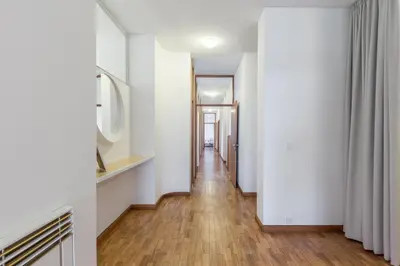a hallway with white walls and a wooden floor at BEST - Trindade Tower in Porto