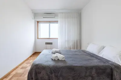 a bedroom with a bed with two towels on it at BEST - Trindade Tower in Porto