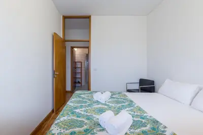 a bedroom with a bed with two heart shaped towels at BEST - Trindade Tower in Porto
