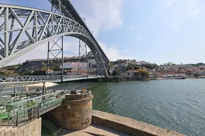 a bridge over a river next to a body of water at FLH Porto Stylish Apartment in Porto