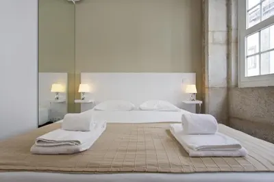 a bedroom with a bed with towels on it at RVA - Clerigos Apartments in Porto
