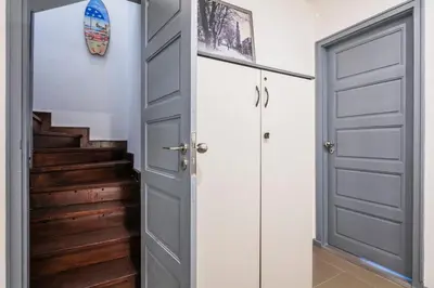 a door leading into a hallway with stairs at Apartamento À Francos Attic in Porto