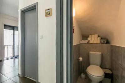 a bathroom with a toilet and a glass door at Apartamento À Francos Gyn Lovers in Porto