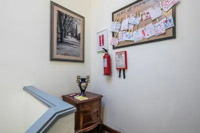 a stairway with a trophy on a table and a wall at Apartamento À Francos Gyn Lovers in Porto