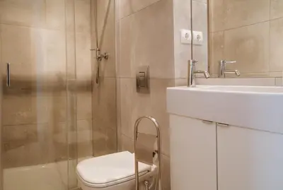 a bathroom with a shower and a toilet and a sink at Porto Spot Hostel in Porto