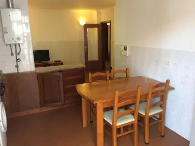a kitchen with a wooden dining table and chairs at Downtown PORTO SE in Porto