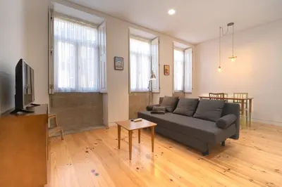 a living room with a couch and a tv at Bonfim 234 Townhouse in Porto