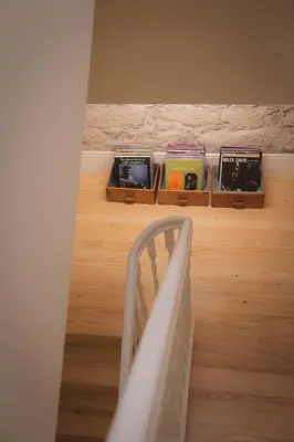 a room with a bed and a shelf with books at Bonfim 234 Townhouse in Porto