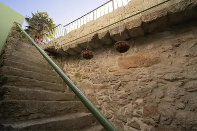 a set of stairs next to a stone wall at Bonfim 234 Townhouse in Porto