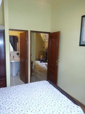 a bedroom with a bed and a door to a hallway at Caldeira Guest House in Porto