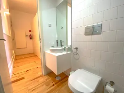a bathroom with a toilet and a sink at CL Ildefonso III Apartment in Porto