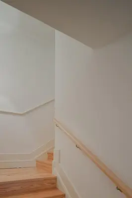 a staircase with white walls and wood floors at CL Ildefonso III Apartment in Porto