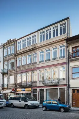 a large building with cars parked in front of it at CL Ildefonso III Apartment in Porto