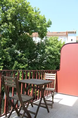 a picnic table and a bench on a balcony at CL Fernandes Tomás I in Porto