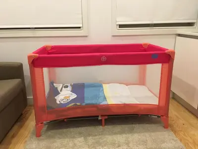 a red bunk bed in a room with a couch at São Bento Golden Flat in Porto