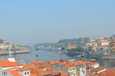 a view of a city with a river and buildings at Modern and Cozy Apartment in Vila Nova de Gaia