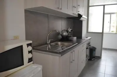 a kitchen with a sink and a microwave at Modern and Cozy Apartment in Vila Nova de Gaia