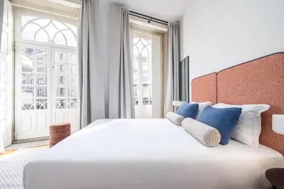 a hotel room with a bed and a couch at Aspasios Trindade Apartments in Porto