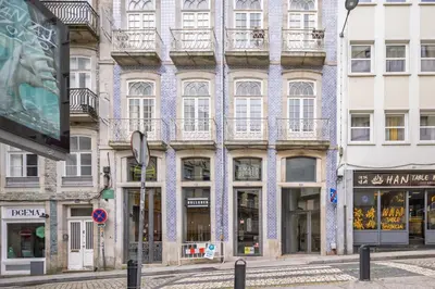 a bedroom with a bed and a desk and a tv at Aspasios Trindade Apartments in Porto