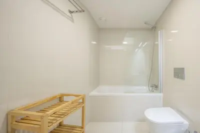 a bedroom with a bed and a desk and a couch at Aspasios Trindade Apartments in Porto