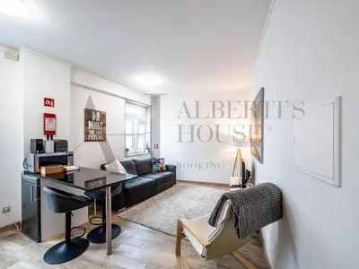 a living room with a desk and a couch at Alberti's House Oporto Central Apartment in Porto