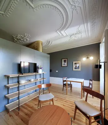 a dining room with a table and chairs and a ceiling at Oporto Maison Batalha in Porto