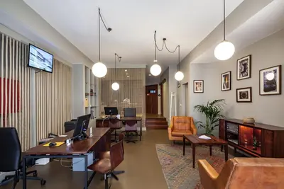 an office with desks and chairs and a living room at Oporto Maison Batalha in Porto