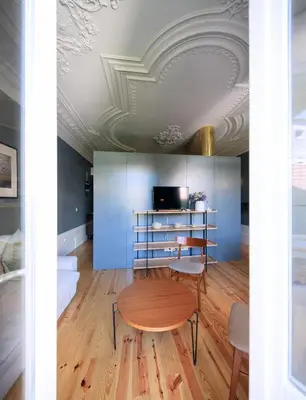 a room with a table and chairs and a ceiling at Oporto Maison Batalha in Porto