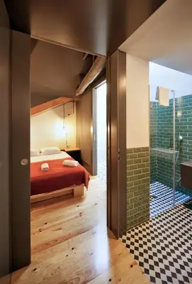 a bedroom with a bed and a shower at Oporto Maison Batalha in Porto
