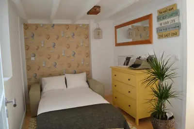 a small bedroom with a bed and a dresser at Wood Loft by RDC in Porto