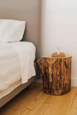 a bedroom with a bed and a wooden stump side table at Wood Loft by RDC in Porto