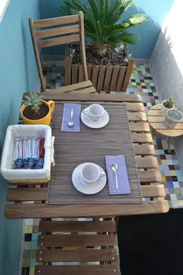 a wooden table with plates and dishes on it at Wood Loft by RDC in Porto