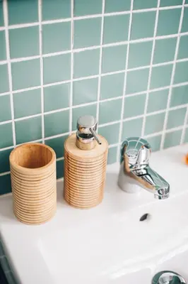 a bathroom sink with two stacks of wooden toiletries at Wood Loft by RDC in Porto