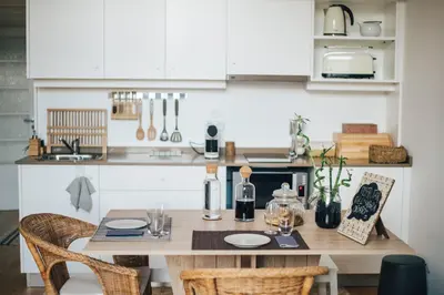 a kitchen with a wooden table with chairs and a counter at Wood Loft by RDC in Porto