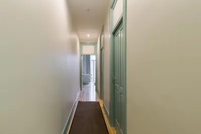 a hallway with green doors and a toilet at Santa Catarina 652 in Porto