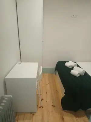 a room with a bed and a desk and towels at Santa Catarina 652 in Porto