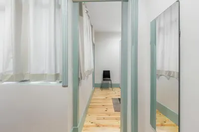 a hallway with a door to a room with a wooden floor at Santa Catarina 652 in Porto