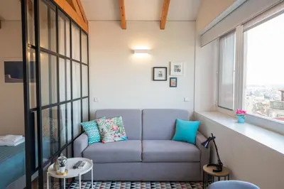 a living room with a couch and a window at Panoramic luxury apartment w AC Downtown and Metro in Porto