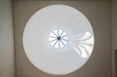a circular window in a room with a white wall at Panoramic luxury apartment w AC Downtown and Metro in Porto