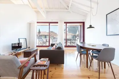 a living room with a couch and a table at LovelyStay - Top Floor Balcony Apartment in Porto
