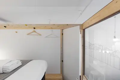 a bedroom with a bed and a glass wall at Goabio apartments 2 river view in Porto