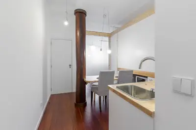 a kitchen with a sink and a table with chairs at Goabio apartments 2 river view in Porto
