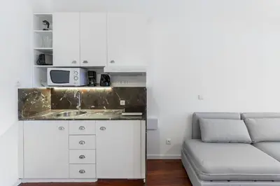 a living room with a couch and a microwave at Goabio apartments 2 river view in Porto
