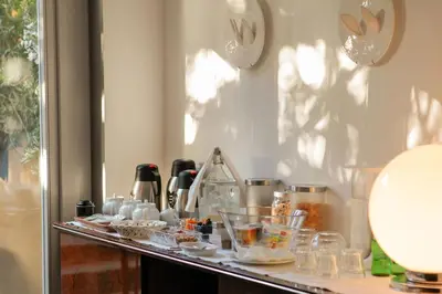 a table with glasses and other items on it at Pensao Favorita in Porto