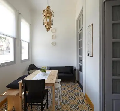 a dining room with a table and chairs and a chandelier at Pensao Favorita in Porto