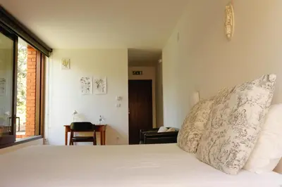 a bedroom with a bed with white sheets and pillows at Pensao Favorita in Porto