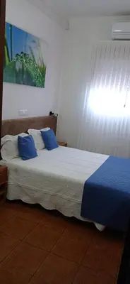 a bedroom with two beds with green pillows on them at Hotel Paulista in Porto